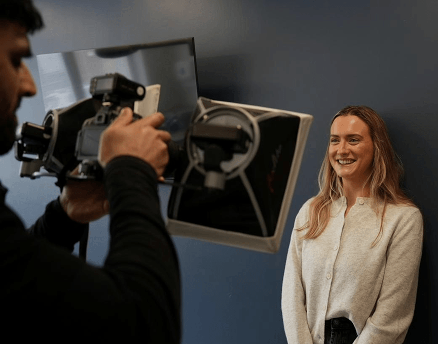 Dr Naeem Ashfaq photographing a smiling patient's results at Regent Dental