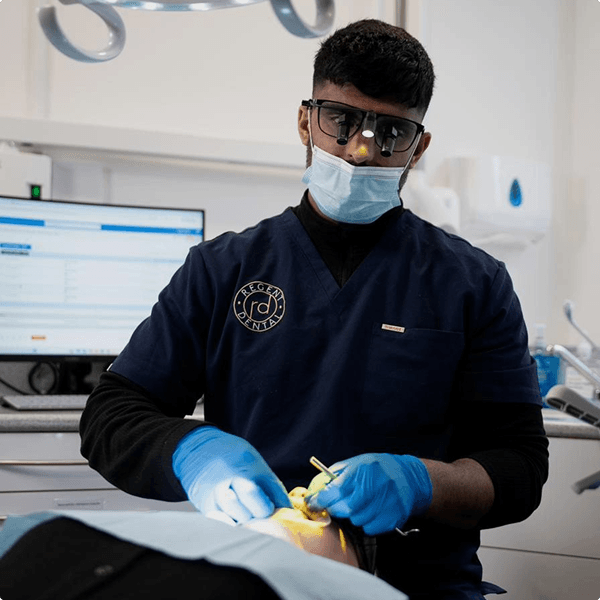 Dr Naeem Ashfaq at the chairside treating a patient at Regent Dental