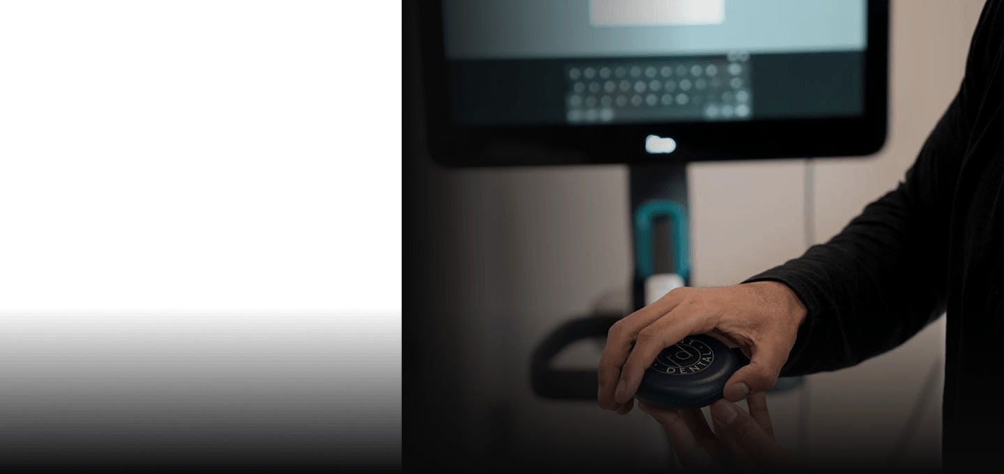 Dr Naeem holding a Regent Dental aligner case beside the 3D scanner
